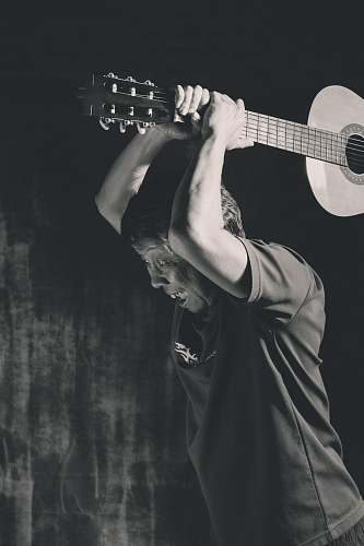 musical instrument man holding classical guitar grey